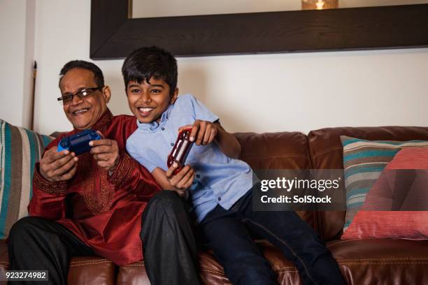 video games with his grandson - bangladeshi man stock pictures, royalty-free photos & images