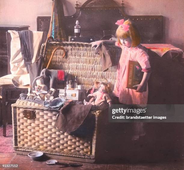 Girl with toys. Austria. Hand-colored lantern slide. Around 1910.