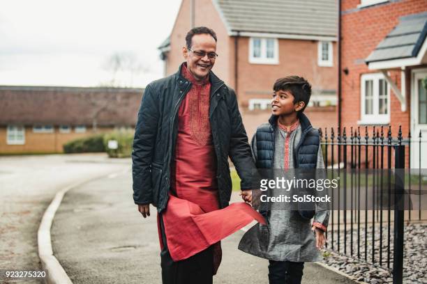 walking with his grandson - islam family stock pictures, royalty-free photos & images