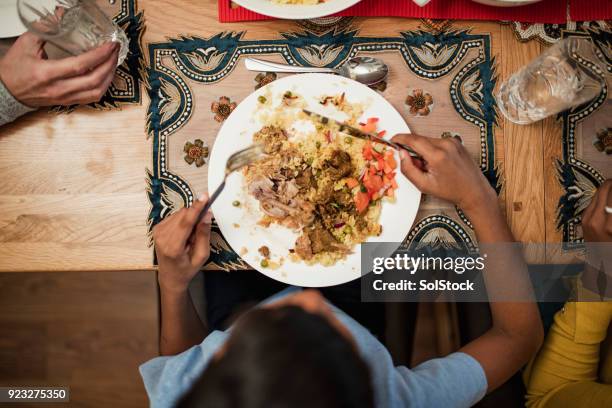 eating a traditional dish - pilau rice stock pictures, royalty-free photos & images