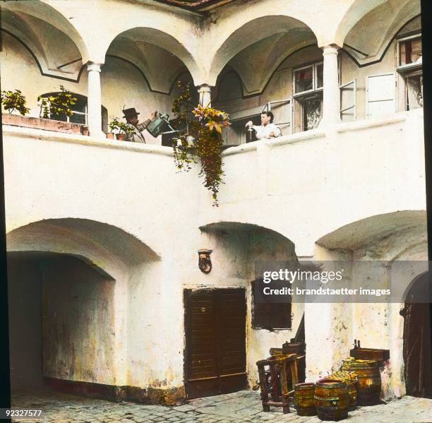 Yard of the old post office in Krems an der Donau. Wachau. Lower Austria. Hand-colored lantern slide. 1910.