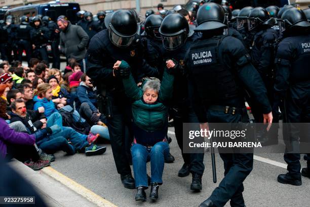 Catalan regional police officers drag a woman during a protest called by the 'Commitees in defence of the Republic' to block the TSJC in Barcelona on...