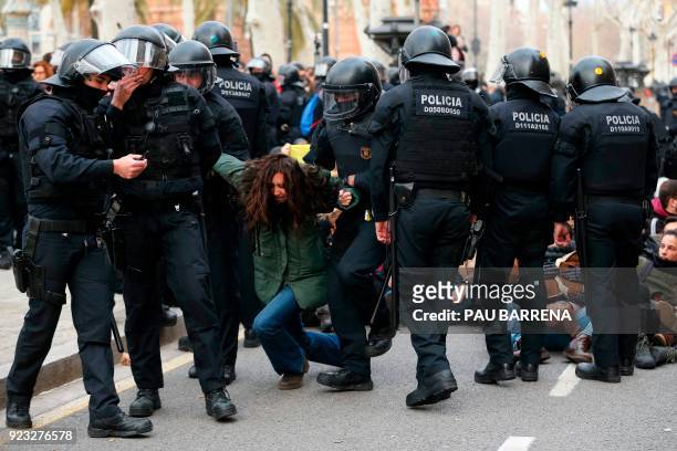 Catalan regional police officers drag a woman during a protest called by the 'Commitees in defence of the Republic' to block the TSJC in Barcelona on...