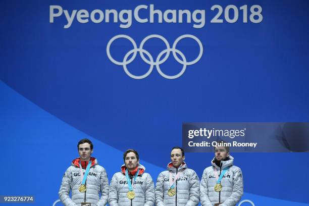 Gold medalists Vinzenz Geiger, Fabian Riessle, Eric Frenzel and Johannes Rydzek of Germany celebrate during the medal ceremony for Nordic Combined -...