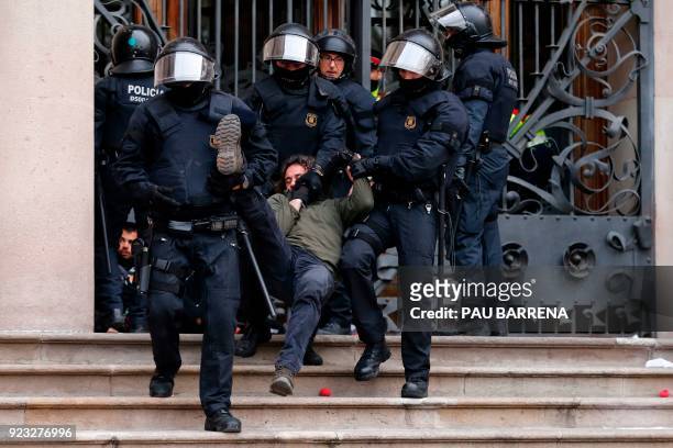 Catalan regional police officers drag a man during a protest called by the 'Commitees in defence of the Republic' to block the TSJC in Barcelona on...