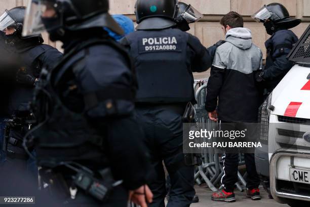 Catalan regional police officers arrest a man during a protest called by the 'Commitees in defence of the Republic' to block the TSJC in Barcelona on...