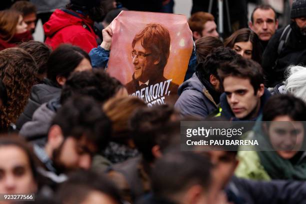 Demonstrator holds a banner of Catalonia's deposed leader Carles Puigdemont during a protest called by the 'Commitees in defence of the Republic' to...