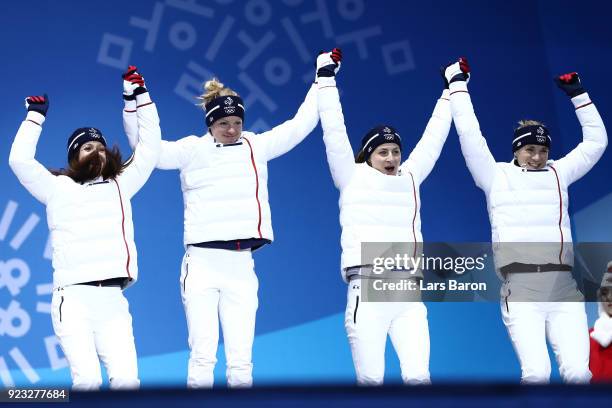 Bronze medalists Anais Chevalier, Marie Dorin Habert, Justine Braisaz and Anais Bescond of France celebrate during the medal ceremony for Biathlon -...