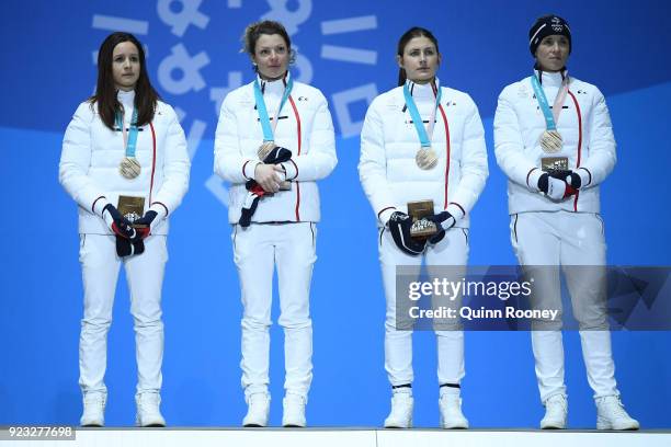 Bronze medalists Anais Chevalier, Marie Dorin Habert, Justine Braisaz and Anais Bescond of France celebrate during the medal ceremony for Biathlon -...