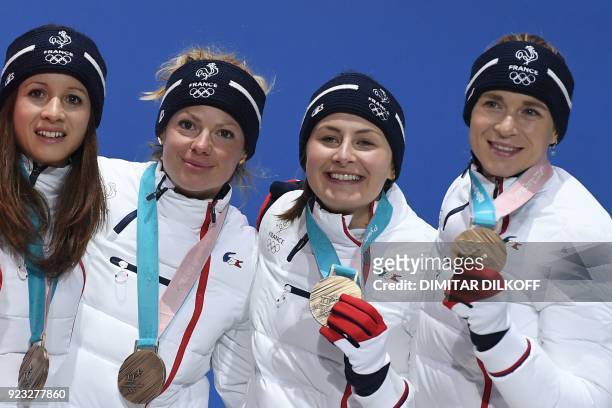 France's bronze medallists Anais Chevalier, Marie Dorin Habert, Justine Braisaz and Anais Bescond pose on the podium during the medal ceremony for...