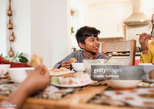 eating dinner with his family - bangladeshi child stock pictures, royalty-free photos & images
