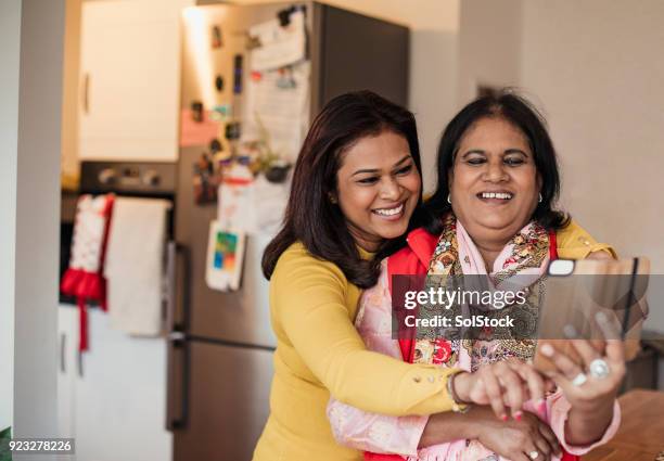 taking a selfie in the kitchen - asian grandmother stock pictures, royalty-free photos & images