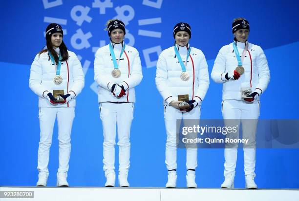 Bronze medalists Anais Chevalier, Marie Dorin Habert, Justine Braisaz and Anais Bescond of France celebrate during the medal ceremony for Biathlon -...