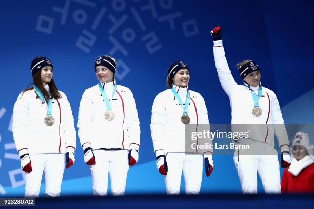 Bronze medalists Anais Chevalier, Marie Dorin Habert, Justine Braisaz and Anais Bescond of France celebrate during the medal ceremony for Biathlon -...