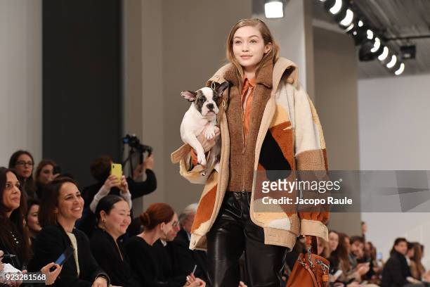 Model Gigi Hadid walks the runway with a dog at the Tod's show during Milan Fashion Week Fall/Winter 2018/19 on February 23, 2018 in Milan, Italy.