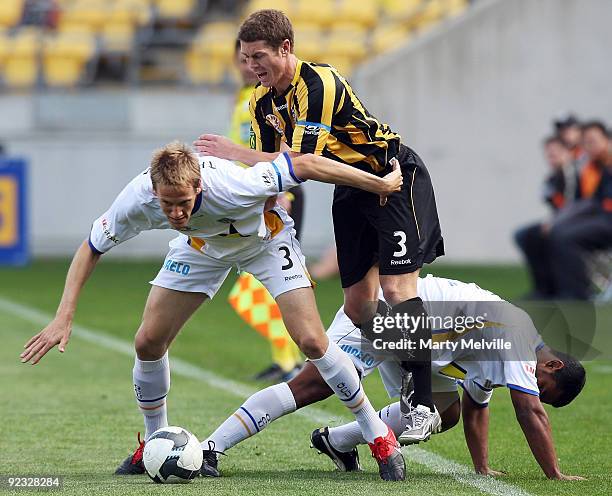 Michael Thwaite of Gold Coast is tackled by Tony Lochhead of the Phoenix during the round 12 A-League match between the Wellington Phoenix and Gold...