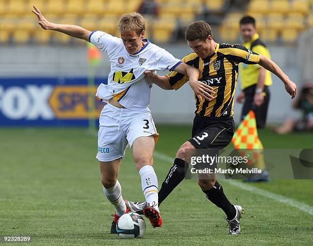 Michael Thwaite of Gold Coast is tackled by Tony Lochhead of the Phoenix during the round 12 A-League match between the Wellington Phoenix and Gold...