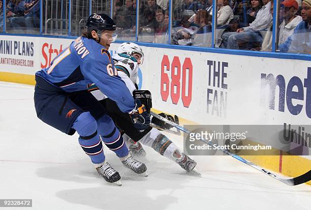 Maxim Afinogenov of the Atlanta Thrashers battles for the puck against Marc-Edouord Vlasic ofthe San Jose Sharks at Philips Arena on October 24, 2009...