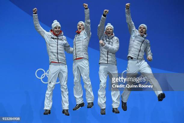 Gold medalists Vinzenz Geiger, Fabian Riessle, Eric Frenzel and Johannes Rydzek of Germany celebrate during the medal ceremony for Nordic Combined -...