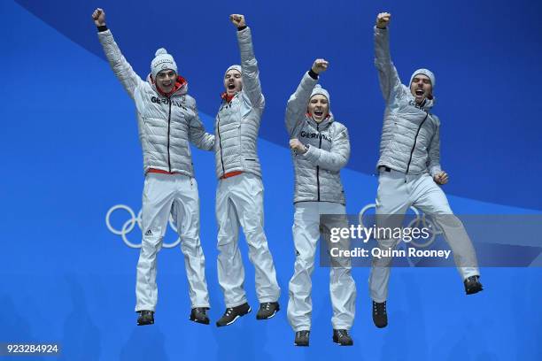 Gold medalists Vinzenz Geiger, Fabian Riessle, Eric Frenzel and Johannes Rydzek of Germany celebrate during the medal ceremony for Nordic Combined -...