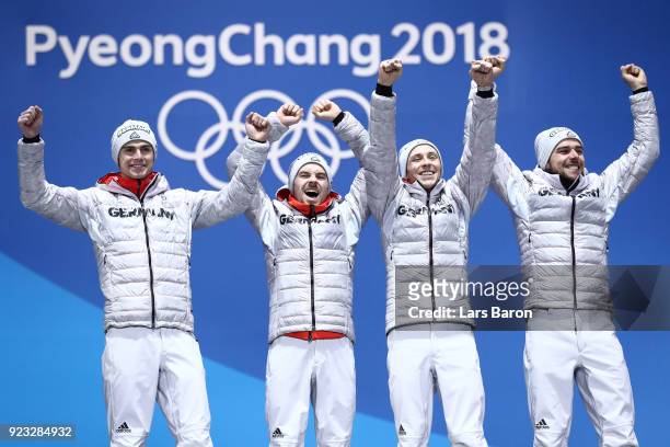 Gold medalists Vinzenz Geiger, Fabian Riessle, Eric Frenzel and Johannes Rydzek of Germany celebrate during the medal ceremony for Nordic Combined -...