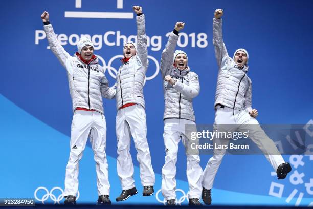 Gold medalists Vinzenz Geiger, Fabian Riessle, Eric Frenzel and Johannes Rydzek of Germany celebrate during the medal ceremony for Nordic Combined -...