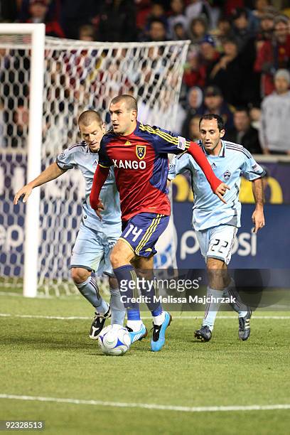 Yura Movsisyan of Real Salt Lake kicks the ball against Nick LaBrocca and Kosuke Kimura of Colorado Rapids at Rio Tinto Stadium on October 24, 2009...