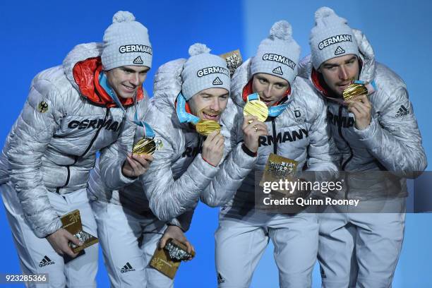 Gold medalists Vinzenz Geiger, Fabian Riessle, Eric Frenzel and Johannes Rydzek of Germany celebrate during the medal ceremony for Nordic Combined -...