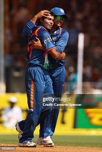 Ravindra Jadeja of India celebrates with team mate Suresh Raina after dismissing Ricky Ponting of Australia during the first One Day International...