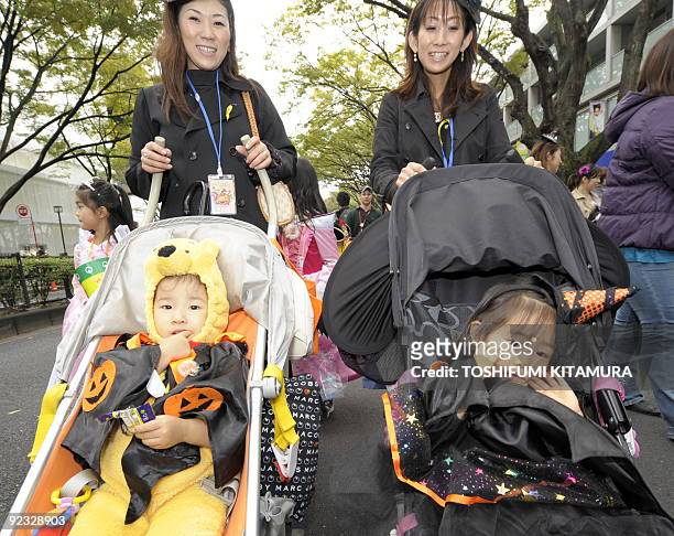 Costumed children join a Halloween parade in Tokyo on October 25, 2009. Some 1,000 children in Halloween costumes took part in the "Harajuku...