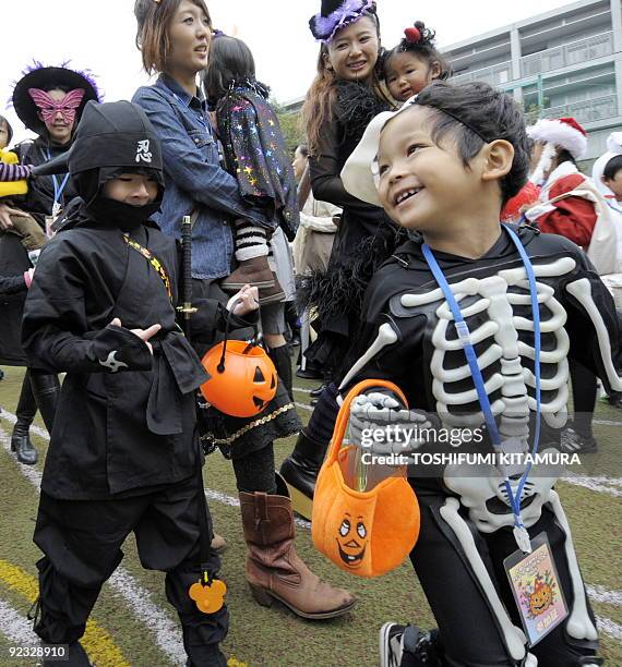 Costumed children join a Halloween parade in Tokyo on October 25, 2009. Some 1,000 children in Halloween costumes took part in the "Harajuku...