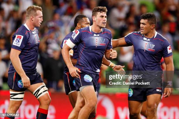 Tom English of the Rebels celebrates a try with teammates during the round two Super Rugby match between the Melbourne Rebels and the Queensland Reds...