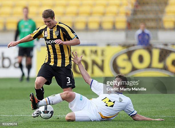 Tony Lochhead of the Phoenix is tackled by Joel Porter of Gold Coast during the round 12 A-League match between the Wellington Phoenix and Gold Coast...