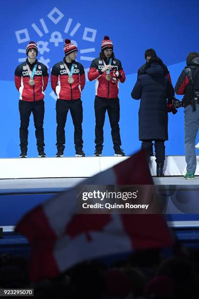 Bronze medalists Samuel Girard, Charles Hamelin, Charle Cournoyer and Pascal Dion of Canada stand on the podium during the medal ceremony for Short...