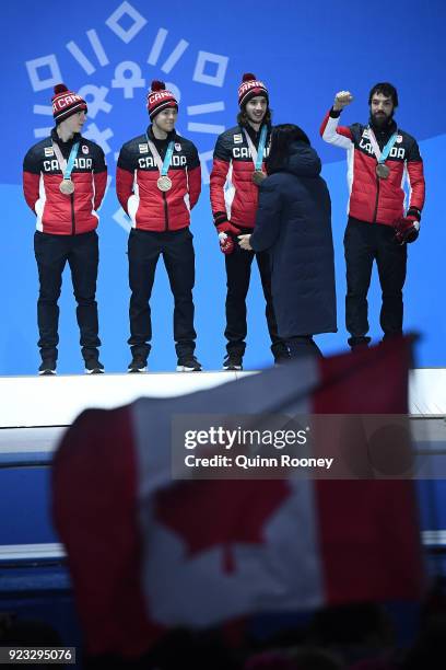 Bronze medalists Samuel Girard, Charles Hamelin, Charle Cournoyer and Pascal Dion of Canada stand on the podium during the medal ceremony for Short...