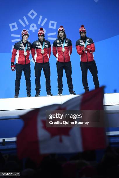 Bronze medalists Samuel Girard, Charles Hamelin, Charle Cournoyer and Pascal Dion of Canada stand on the podium during the medal ceremony for Short...