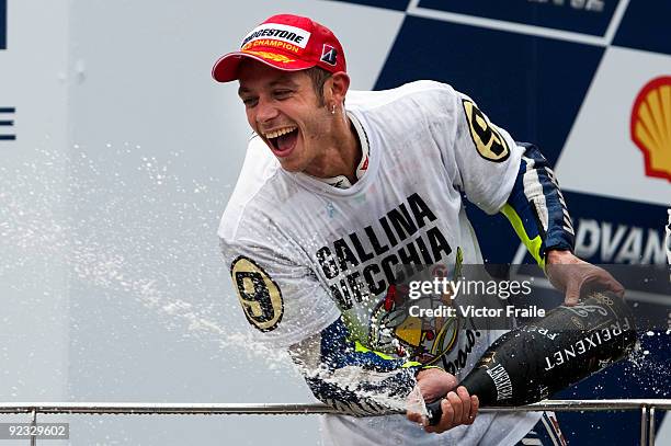 Fiat Yamaha Team rider Valentino Rossi of Italy celebrates after winning his ninth MotoGP World Championship with his third place in the Malaysian...