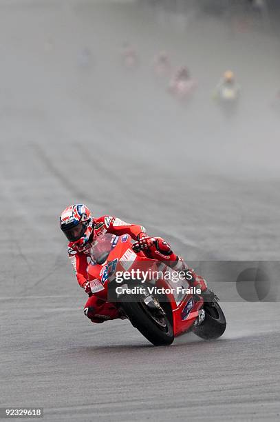 Casey Stoner of Australia rides the Ducati Marlboro Team Ducati to win the Malaysian MotoGP, which is round 16 of the MotoGP World Championship at...