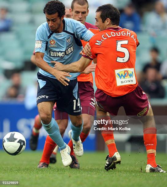 Alex Brosque of Sydney FC evades defender Josh McCloughan of the Roar on his way to scoring a goal during the round 12 A-League match between Sydney...