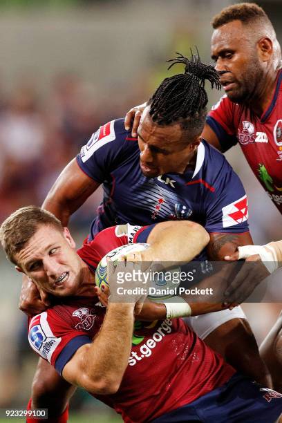 James Tuttle of the Reds and Will Genia of the Rebels contest the ball during the round two Super Rugby match between the Melbourne Rebels and the...