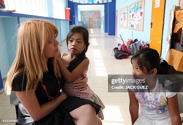 Children of illegal foreign workers in Israel speak with their school principal Yael Klein in Tel Aviv on October 19, 2009. Some 1,200 Asian and...