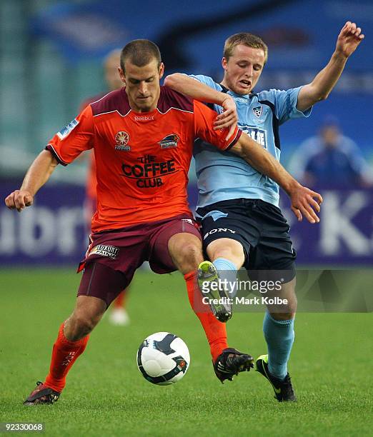 Matthew Mundy of the Roar and Shannon Grant of Sydney FC compete for the ball during the round 12 A-League match between Sydney FC and the Brisbane...