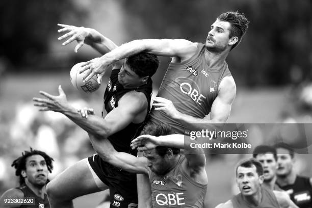 Jonathon Patton of the Giants attempts to mark under pressure from Nick Smith and Harrison Marsh of the Swans during the AFL Inter Club match between...