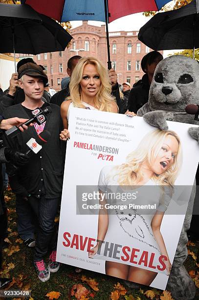 Designer Richie Rich and Pamela Anderson appear with a person dressed as a baby seal to unveil a new PETA campaign at the Ontario Legislative...