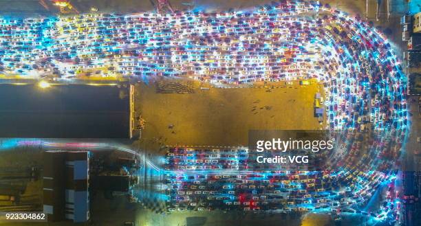 Aerial view of vehicles waiting for ferry service as the weeklong Chinese New Year holiday comes to an end at a port on February 21, 2018 in Haikou,...