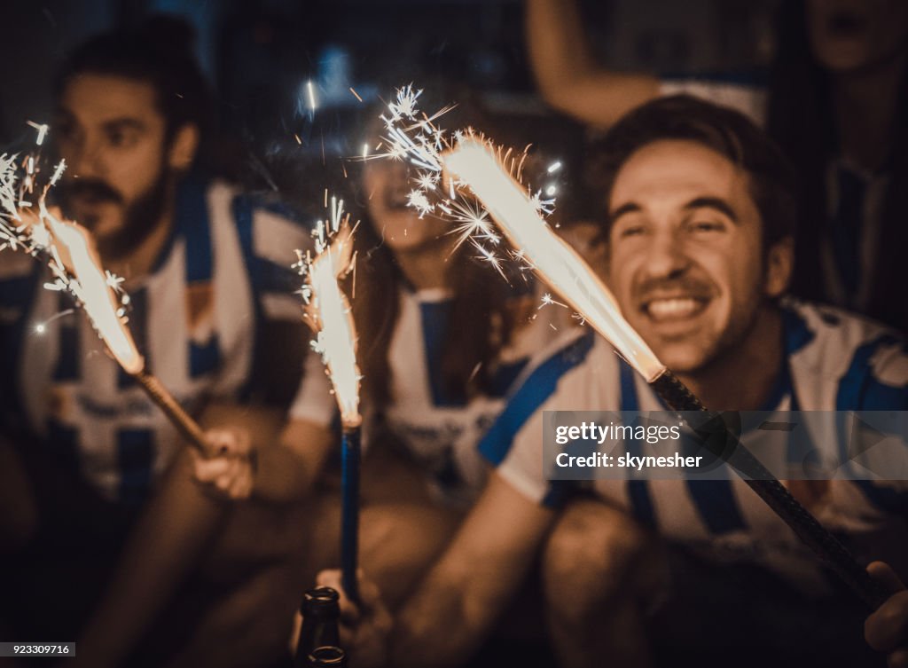 Sports fans having fun with torches at home!