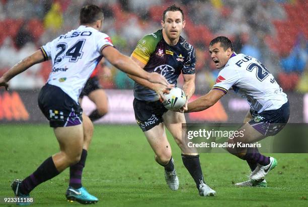 Michael Morgan of the Cowboys takes on the defence during the NRL trial match and Jonathan Thurston/Cameron Smith Testimonial match between the...