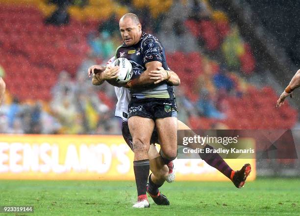 Matthew Scott of the Cowboys attempts to break through the defence during the NRL trial match and Jonathan Thurston/Cameron Smith Testimonial match...