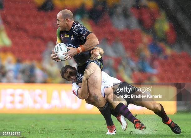 Matthew Scott of the Cowboys attempts to break through the defence during the NRL trial match and Jonathan Thurston/Cameron Smith Testimonial match...