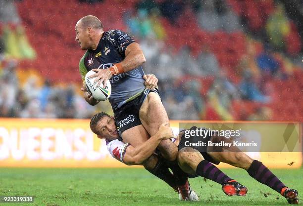 Matthew Scott of the Cowboys attempts to break through the defence during the NRL trial match and Jonathan Thurston/Cameron Smith Testimonial match...